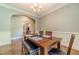 Traditional dining room featuring hardwood flooring, elegant chandelier, and access to other rooms at 1609 Holly Ridge Dr, Loganville, GA 30052