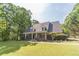 Well-manicured lawn and mature landscaping highlight this home with front porch and dormer windows at 1609 Holly Ridge Dr, Loganville, GA 30052