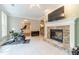 Open layout fitness area with tiled floor and stone fireplace offering a comfortable workout environment at 1609 Holly Ridge Dr, Loganville, GA 30052