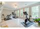 Bright and spacious gym area with tiled floors, large windows, and a variety of exercise equipment at 1609 Holly Ridge Dr, Loganville, GA 30052