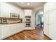 Eat-in kitchen features stainless steel appliances and arched entrance to dining area at 1609 Holly Ridge Dr, Loganville, GA 30052