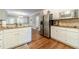 Bright kitchen features white cabinets, granite countertops and stainless-steel appliances at 1609 Holly Ridge Dr, Loganville, GA 30052