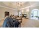 Cozy living room with stone fireplace, neutral decor, and seamless access to other parts of the home at 1609 Holly Ridge Dr, Loganville, GA 30052