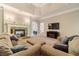 Comfortable living room featuring a stone fireplace and neutral tones, perfect for relaxation and entertaining at 1609 Holly Ridge Dr, Loganville, GA 30052