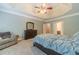 Spacious main bedroom with trey ceiling and ensuite bathroom at 1609 Holly Ridge Dr, Loganville, GA 30052