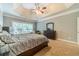 Spacious main bedroom with trey ceiling, neutral colors, and large window allowing natural light at 1609 Holly Ridge Dr, Loganville, GA 30052