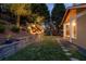 A beautiful backyard at dusk featuring an outdoor dining area, a playset, and mature landscaping at 2580 Glaramara Ter, Cumming, GA 30041