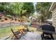 The backyard features a patio with outdoor seating, a barbecue grill and a playset for outdoor Gathering fun at 2580 Glaramara Ter, Cumming, GA 30041