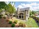 Landscaped backyard with lawn, patio, and enclosed porch addition to the home at 2580 Glaramara Ter, Cumming, GA 30041