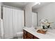 Bathroom with large vanity, mirror, and shower with curtain at 2580 Glaramara Ter, Cumming, GA 30041