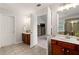 Bathroom with double sink vanity, ceramic tile flooring, and doorway to main bedroom at 2580 Glaramara Ter, Cumming, GA 30041