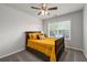 Bedroom featuring a ceiling fan, carpet, a bed with yellow bedding and natural light at 2580 Glaramara Ter, Cumming, GA 30041
