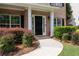 A welcoming front door with manicured landscaping and brick accents at 2580 Glaramara Ter, Cumming, GA 30041