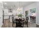 Eat-in kitchen featuring white cabinets, stainless steel appliances, and a view to the covered patio at 2580 Glaramara Ter, Cumming, GA 30041