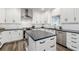 Bright kitchen showcasing stainless steel appliances, stylish white cabinetry, granite countertops, and a functional island at 2580 Glaramara Ter, Cumming, GA 30041