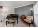 A cozy and quaint living room featuring a piano and warm interior design at 2580 Glaramara Ter, Cumming, GA 30041