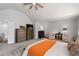 Spacious main bedroom with neutral paint, tray ceilings, carpet, and a ceiling fan at 2580 Glaramara Ter, Cumming, GA 30041
