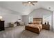 Spacious main bedroom with a vaulted ceiling, neutral carpet, and natural light at 2580 Glaramara Ter, Cumming, GA 30041