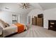 Spacious main bedroom with neutral paint, tray ceilings, carpet, and access to the main bath at 2580 Glaramara Ter, Cumming, GA 30041