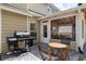 A covered porch boasts an outdoor kitchen and dining and lounge areas for comfortable enjoyment at 2580 Glaramara Ter, Cumming, GA 30041