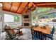 Screened-in sunroom with stone fireplace, wood ceiling and a view of the backyard at 2580 Glaramara Ter, Cumming, GA 30041