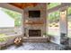 Inviting sunroom with stone fireplace, large windows, and decorative water feature for year-round relaxation at 2580 Glaramara Ter, Cumming, GA 30041