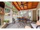Relaxing sunroom with stone fireplace, vaulted wood ceiling and views of backyard landscape at 2580 Glaramara Ter, Cumming, GA 30041