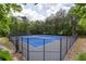 View of community tennis courts featuring new blue playing surface and black fence at 2580 Glaramara Ter, Cumming, GA 30041