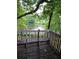 Relax on the back deck with stunning waterfront views and a serene natural setting, perfect for enjoying the outdoors at 2914 Landmark Se Dr, Conyers, GA 30094
