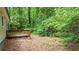 Private backyard featuring a wooden deck nestled amongst lush greenery at 3117 Calumet Nw Cir, Kennesaw, GA 30152