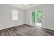 Bright bedroom with modern vinyl flooring and a sliding glass door leading to the deck at 3117 Calumet Nw Cir, Kennesaw, GA 30152