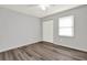 Bedroom with wood-look floors, a ceiling fan, and a bright window at 3117 Calumet Nw Cir, Kennesaw, GA 30152