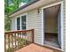 Charming entryway features a wood deck and an open door to a home with modern vinyl floors at 3117 Calumet Nw Cir, Kennesaw, GA 30152