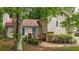 Charming home featuring a front entrance with a small deck and cozy setting among lush greenery and mature trees at 3117 Calumet Nw Cir, Kennesaw, GA 30152