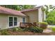 Home featuring a front entrance with a small deck and cozy setting among lush greenery and mature trees at 3117 Calumet Nw Cir, Kennesaw, GA 30152
