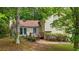 Exterior featuring a charming facade with a deck and entrance, complemented by mature trees and a well-kept lawn at 3117 Calumet Nw Cir, Kennesaw, GA 30152
