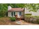 Inviting entrance enhanced with a charming deck, lush greenery, and a well-maintained lawn at 3117 Calumet Nw Cir, Kennesaw, GA 30152