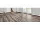 Open-concept living room featuring elegant gray vinyl floors, neutral walls, and a bright window at 3117 Calumet Nw Cir, Kennesaw, GA 30152