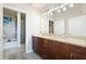 Bathroom featuring double sinks with dark wood cabinets and granite countertops with shower and soaking tub at 400 W Peachtree Nw St # 3801, Atlanta, GA 30308
