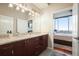 Bathroom with double sinks, granite countertops, and an open door into the bedroom at 400 W Peachtree Nw St # 3801, Atlanta, GA 30308