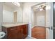 A bathroom features wooden cabinets, granite countertops, a large mirror, and tile flooring at 400 W Peachtree Nw St # 3801, Atlanta, GA 30308