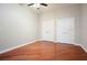 Empty bedroom with hardwood floors, ceiling fan, and two closet doors at 400 W Peachtree Nw St # 3801, Atlanta, GA 30308