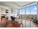 Bright dining area features hardwood floors, modern table with seating, and expansive windows with views at 400 W Peachtree Nw St # 3801, Atlanta, GA 30308
