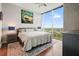 Serene bedroom with a large window showcasing a city view, complemented by stylish decor and soft lighting at 400 W Peachtree Nw St # 3801, Atlanta, GA 30308