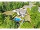 An aerial view of a beautiful home featuring a backyard pool and a lush, landscaped yard at 110 Hawks Bnd, Canton, GA 30115