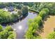 Expansive lakefront property showcasing a large home with a backyard pool, a private dock, and stunning natural surroundings at 110 Hawks Bnd, Canton, GA 30115