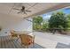 Relax on the covered back deck with wicker furniture and a ceiling fan overlooking the fenced backyard at 110 Hawks Bnd, Canton, GA 30115