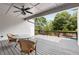 Back deck with seating area offering beautiful views of the surrounding greenery and backyard pool at 110 Hawks Bnd, Canton, GA 30115