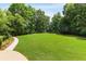 Spacious backyard with lush lawn and mature trees for outdoor activities at 110 Hawks Bnd, Canton, GA 30115