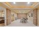 Finished basement with brick walls, a game table, and a cozy seating area at 110 Hawks Bnd, Canton, GA 30115
